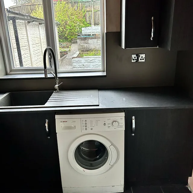 black kitchen with washing machine